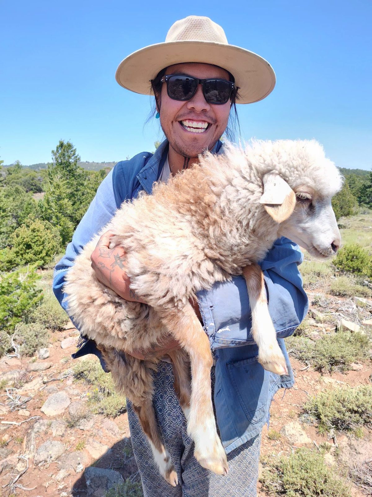 Carrying a churro lamb at the camp
