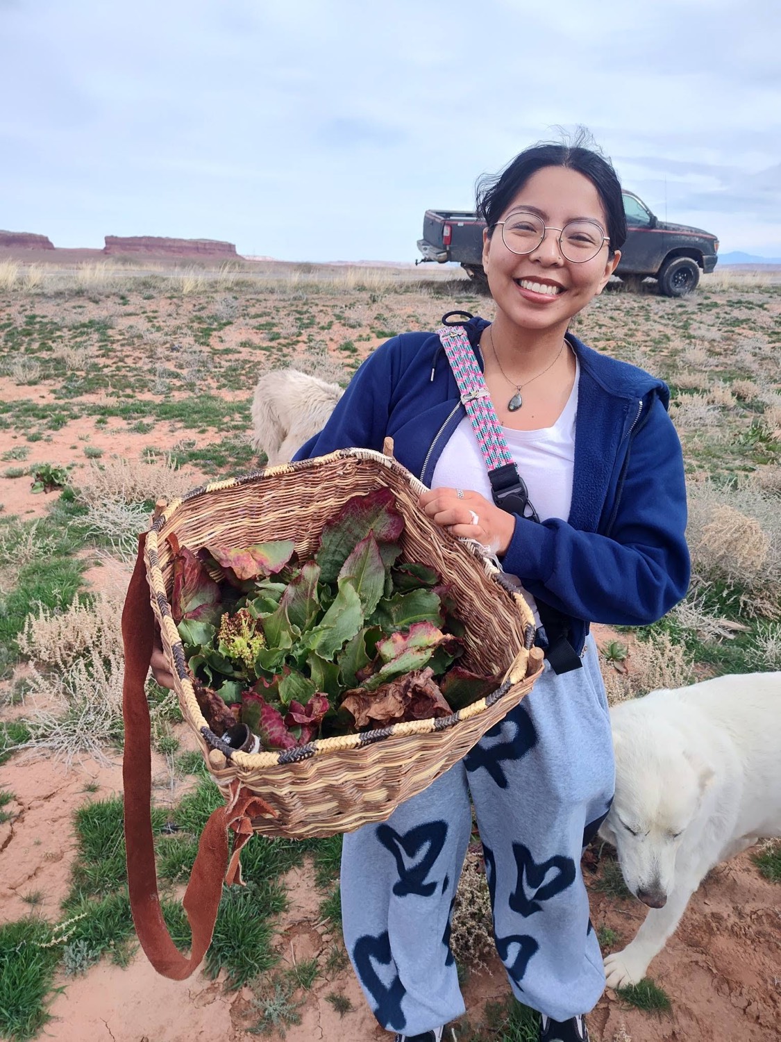 An apprentice with a basket of gathered greens